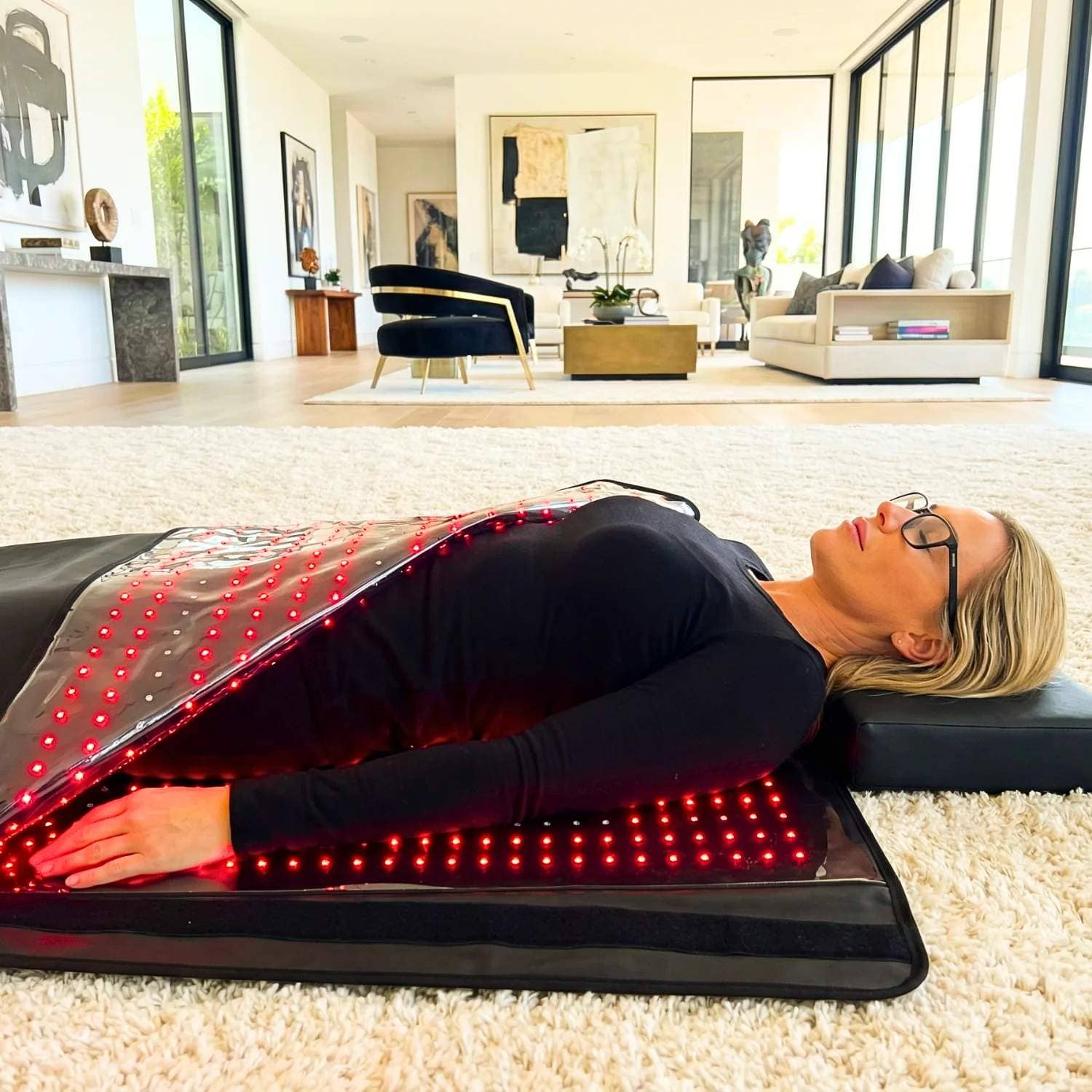 Person relaxing inside a full body red light therapy blanket at home